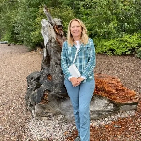 Cheri Gaylord, Founder & Principal Consultant of Nurtured Minds, standing outdoors.